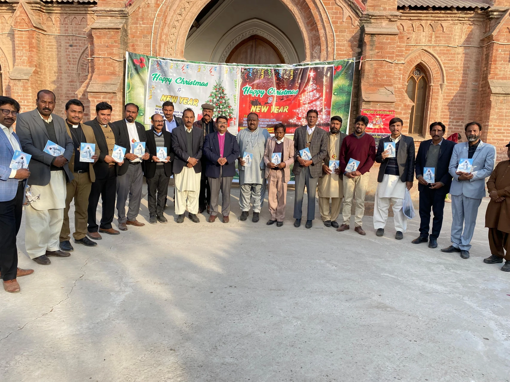 Pastors holding copies of the lectionary outside the Cathedral