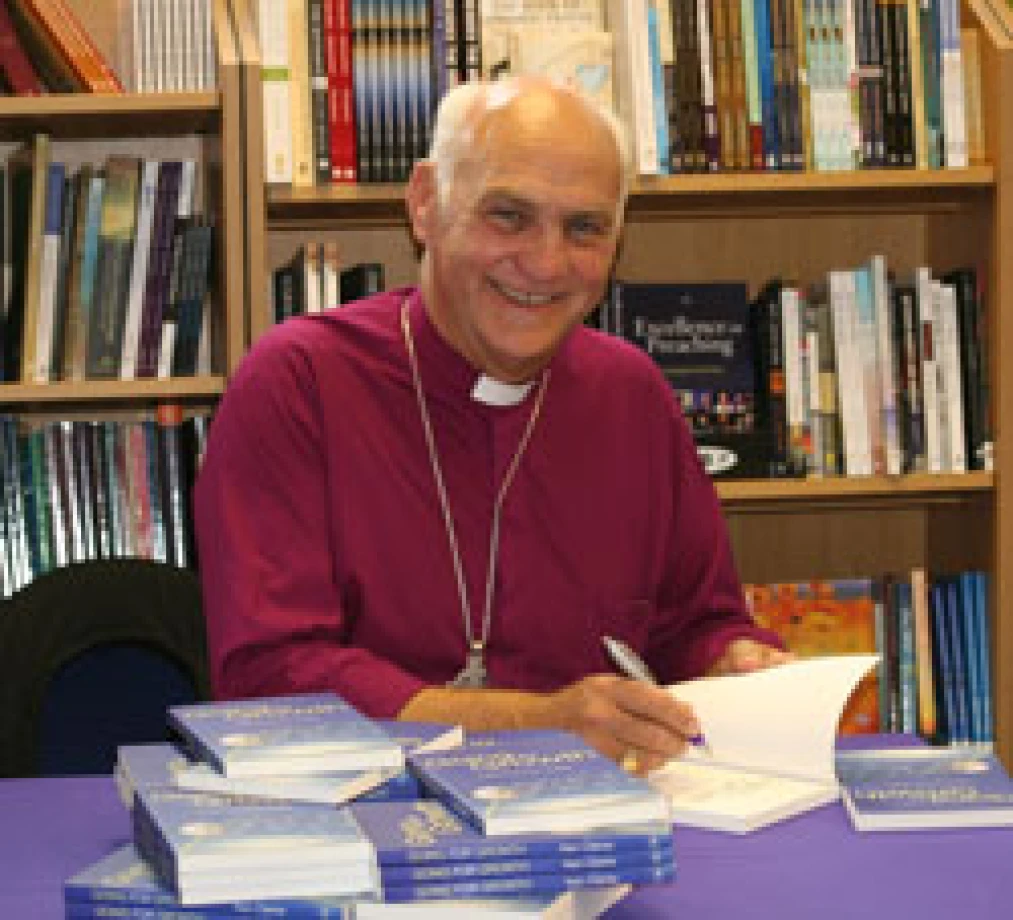 Bishop Ken Clarke signs copies of his new book