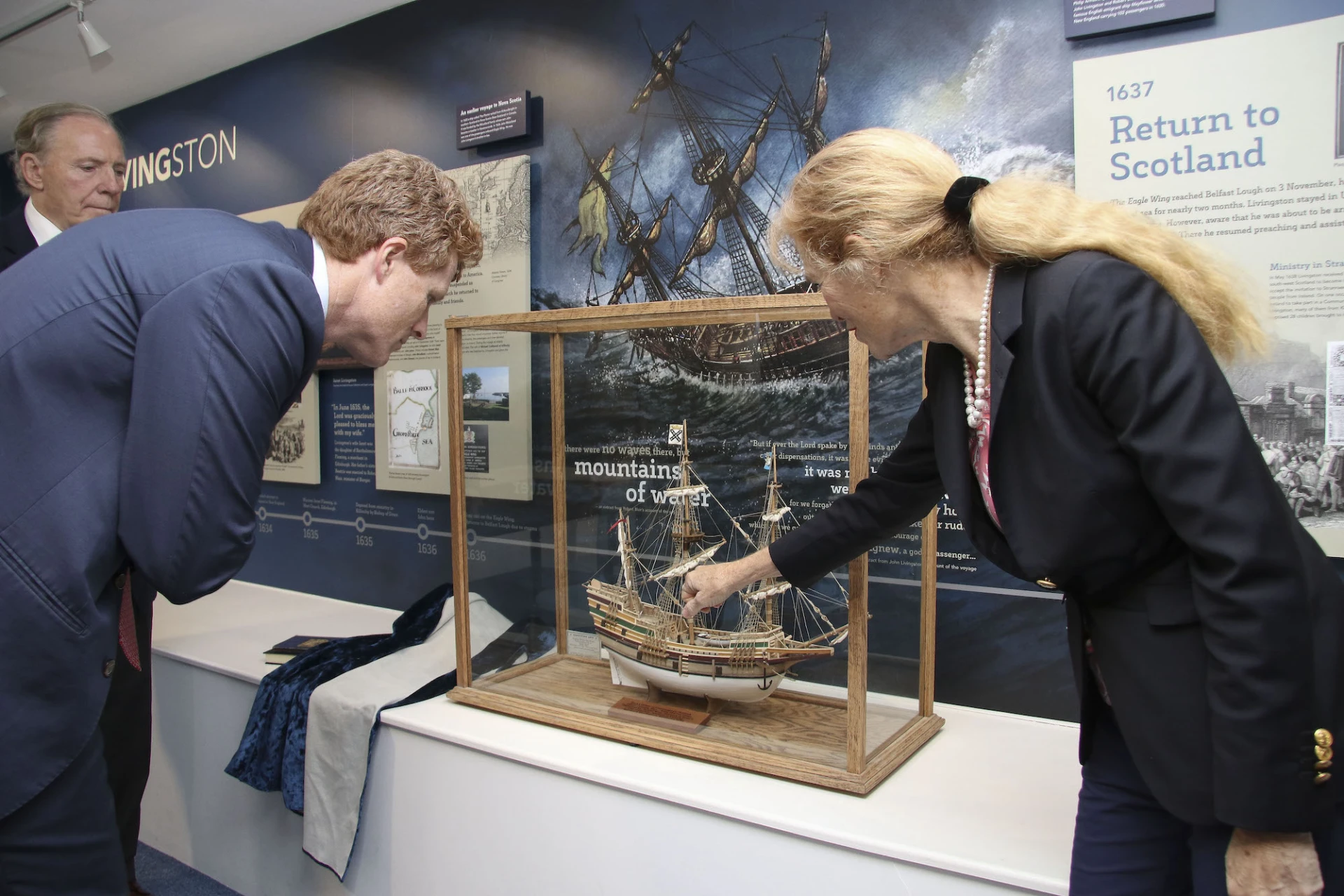 Susan Livingston shows Joe Kennedy III a model of the Eagle Wing